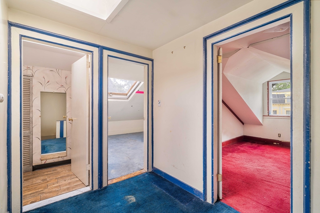 18 Westminster Avenue Boston, MA 02119 - Photo 25 of 37 a view of an hallway with wooden floor and a bathroom