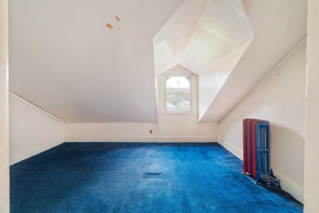18 Westminster Avenue Boston, MA 02119 - Photo 28 of 37 an empty room with wooden floor and white walls