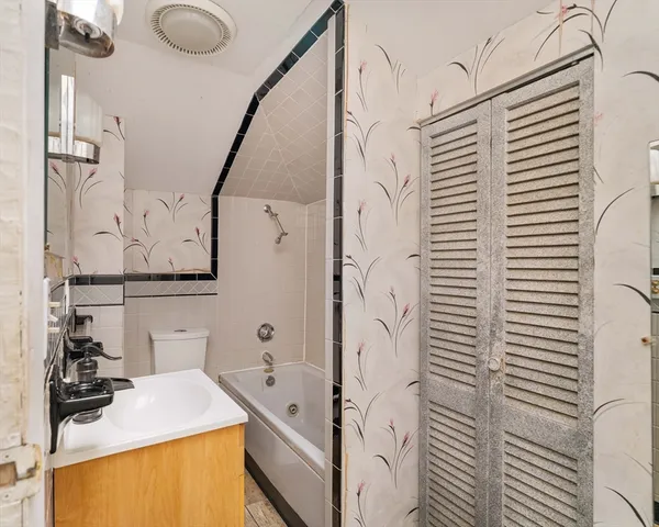 a bathroom with a sink a toilet and mirror