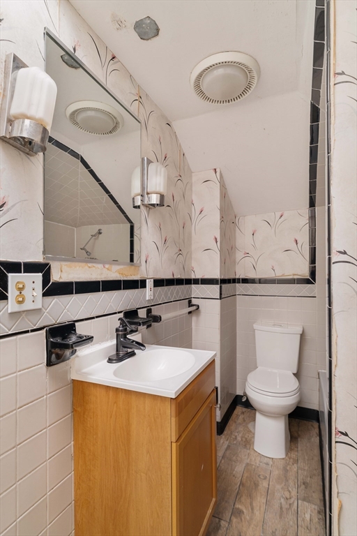18 Westminster Avenue Boston, MA 02119 - Photo 30 of 37 a bathroom with a sink a toilet and mirror