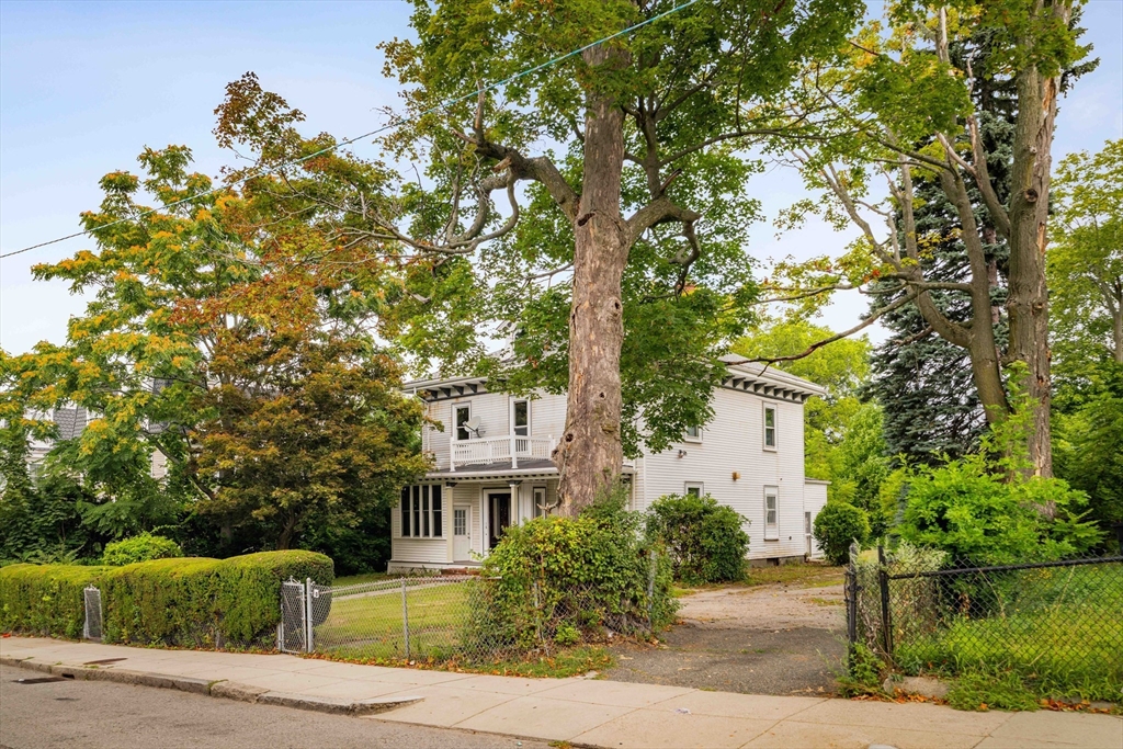 18 Westminster Avenue Boston, MA 02119 - Photo 33 of 37 a front view of a house with a yard and tree s