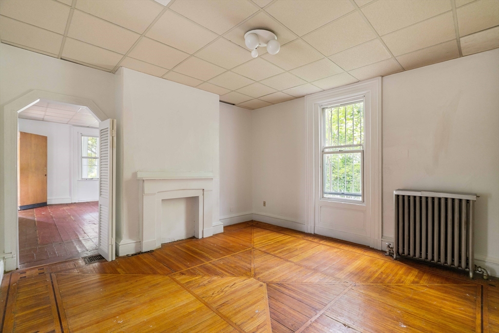 18 Westminster Avenue Boston, MA 02119 - Photo 7 of 37 a bedroom with a bed and a window