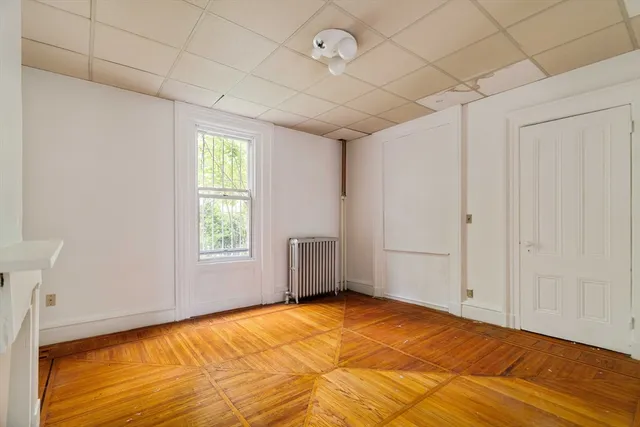 a view of empty room with window and ceiling fan