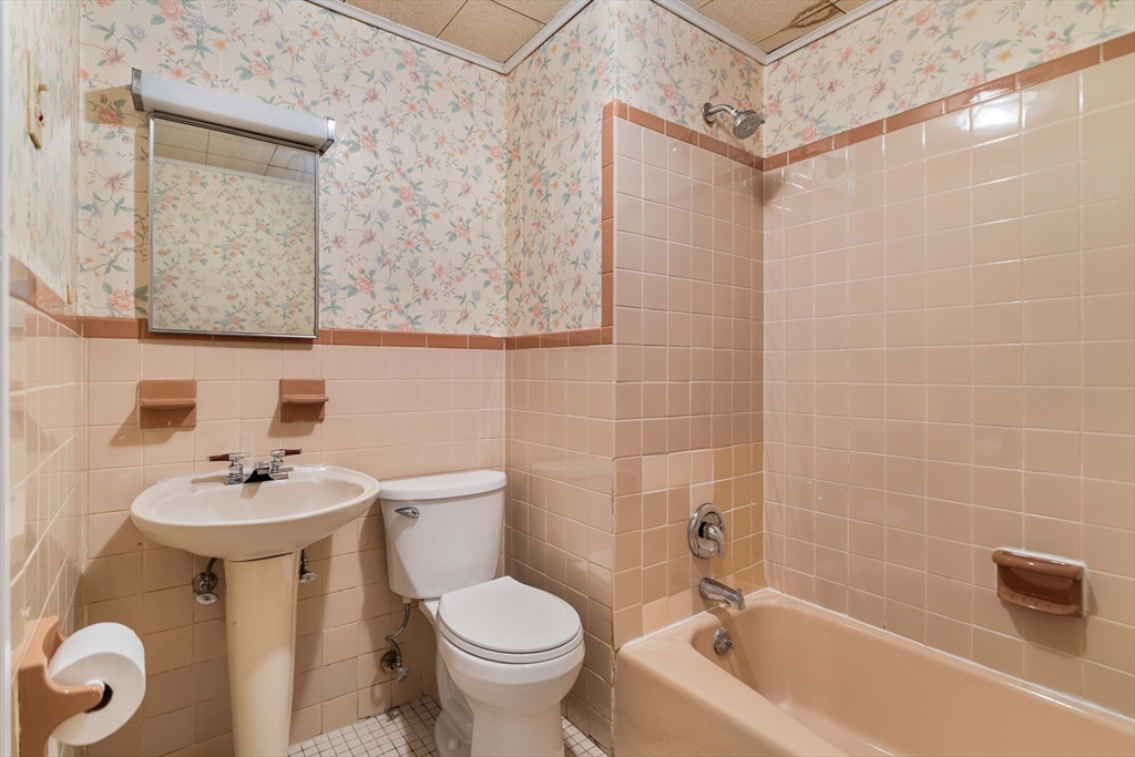 18 Westminster Avenue Boston, MA 02119 - Photo 9 of 37 a bathroom with a sink a toilet and shower