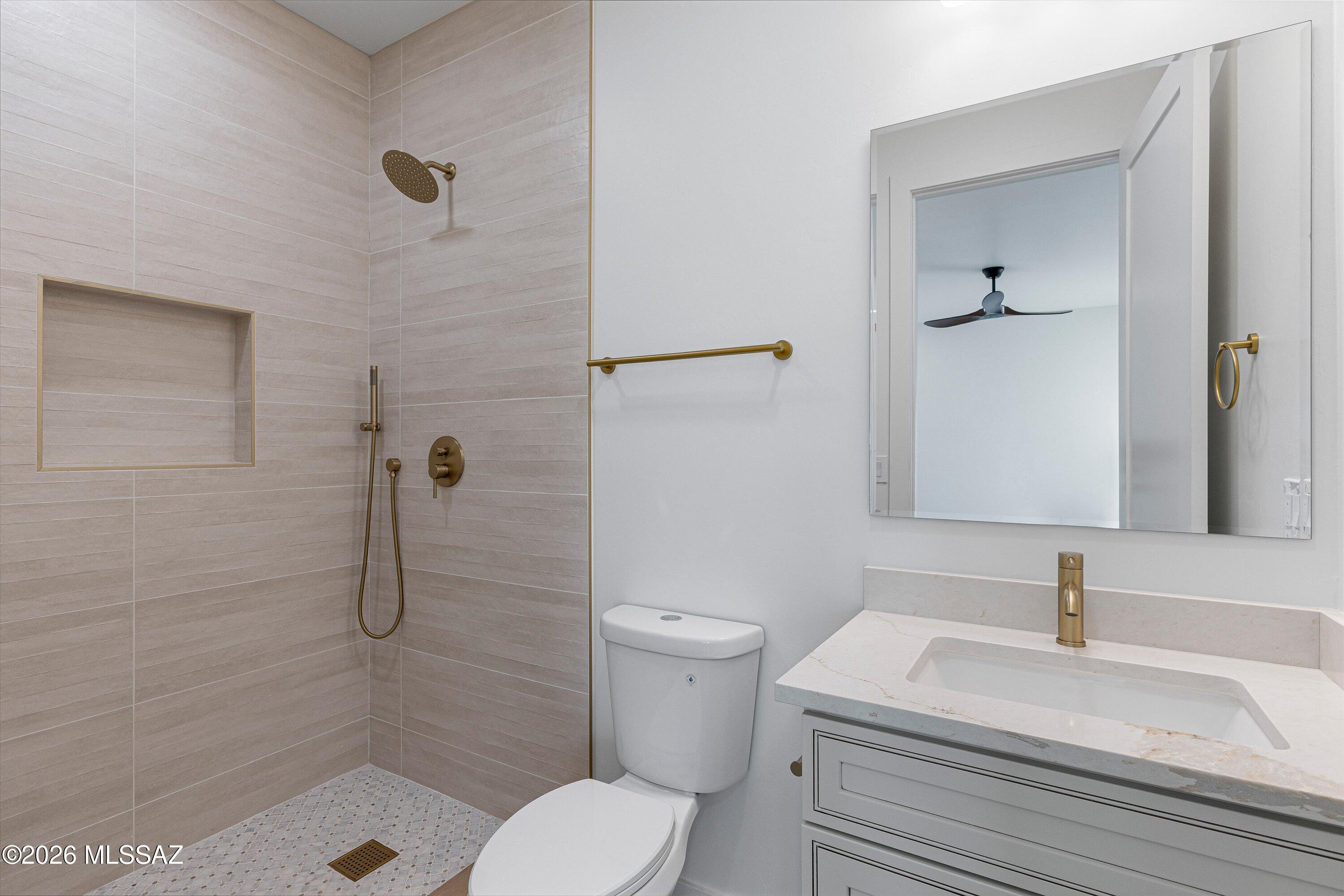 5259 East Fort Lowell Road Tucson, AZ 85712 - Photo 32 of 50 a bathroom with a sink a toilet and shower