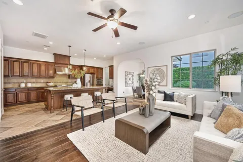 a kitchen with stainless steel appliances granite countertop a refrigerator a sink and a stove