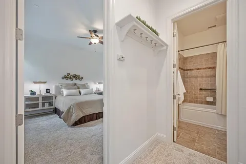 a view of a hallway with bedroom and windows