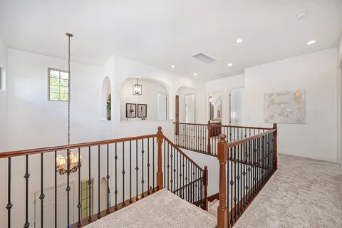 a bathroom with a granite countertop sink a toilet a large mirror and shower