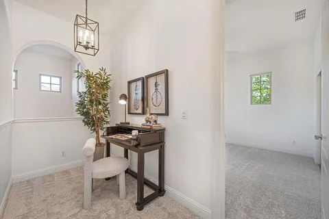 a bed room with a bed and a chandelier