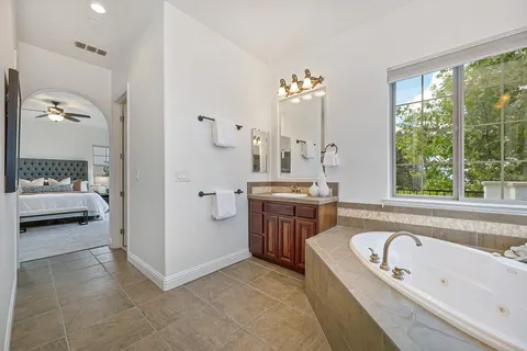 a view of a house with swimming pool and sitting area
