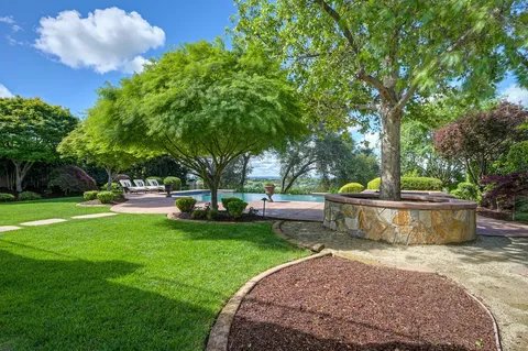 a view of a patio with table and chairs and potted plants