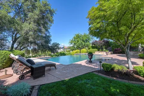 a view of an outdoor dining space with a table and chairs