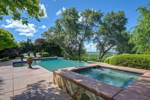 a view of a backyard with sitting area