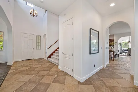a living room with fireplace furniture and a large window