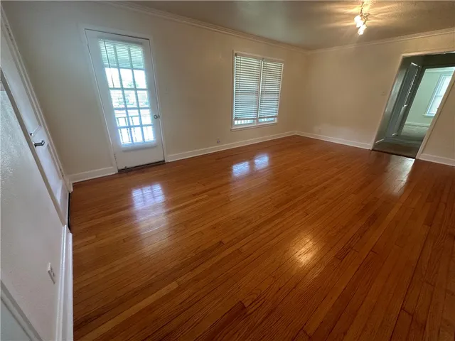 a view of a room with wooden floor and staircase