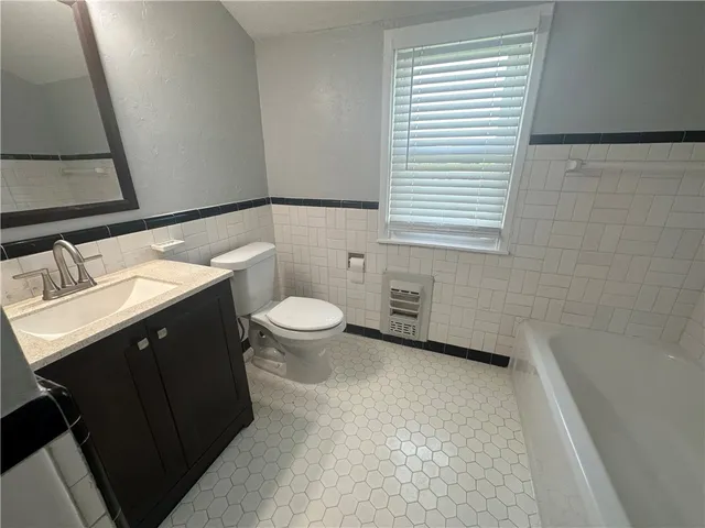 a bathroom with a bathtub and shower