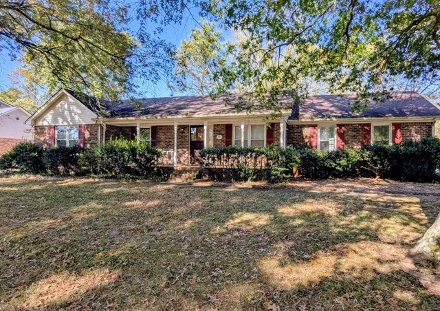 a front view of house with yard and green space