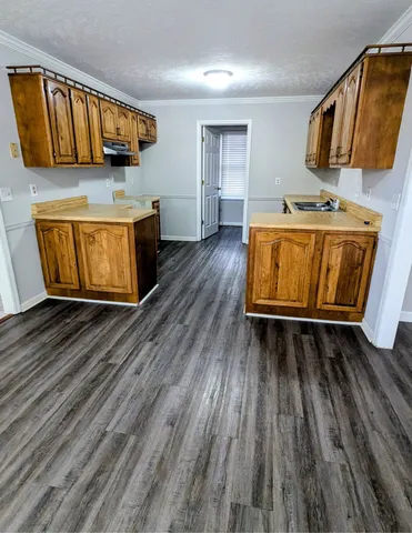 a room with wooden floors and couch