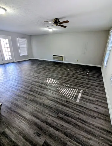 a view of a room with wooden floor