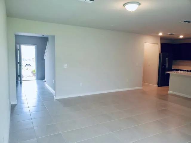 a view of a hallway with wooden shelves