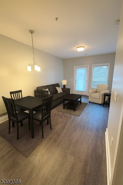 241 Ridge Road North Arlington, NJ 07031 - Photo 6 of 14 a living room with furniture a dining table and a chandelier