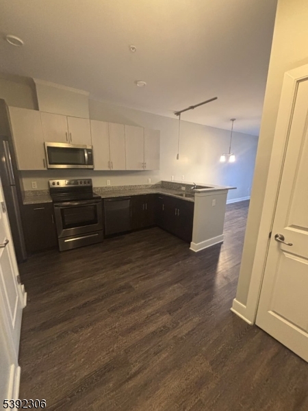 241 Ridge Road North Arlington, NJ 07031 - Photo 7 of 14 a kitchen with granite countertop a refrigerator and a stove top oven