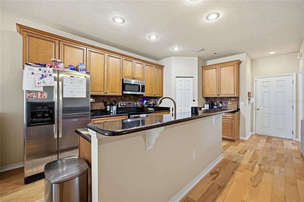 7550 Southwest 81st Way Gainesville, FL 32608 - Photo 10 of 31 a kitchen with stainless steel appliances granite countertop a refrigerator sink and cabinets