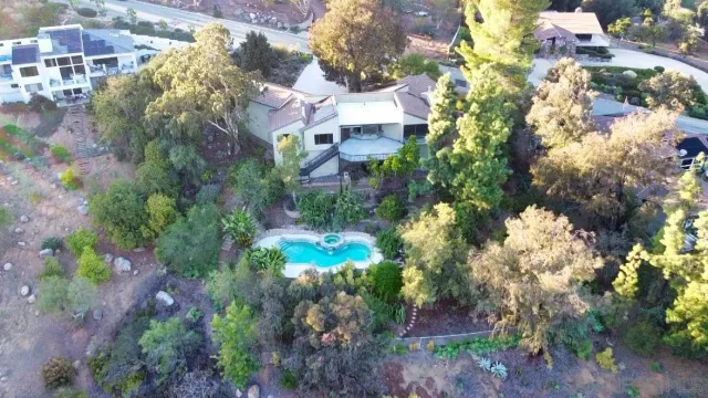 a view of a house with a yard and garden