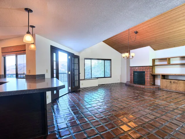 a view of a room with wooden floor and a fireplace