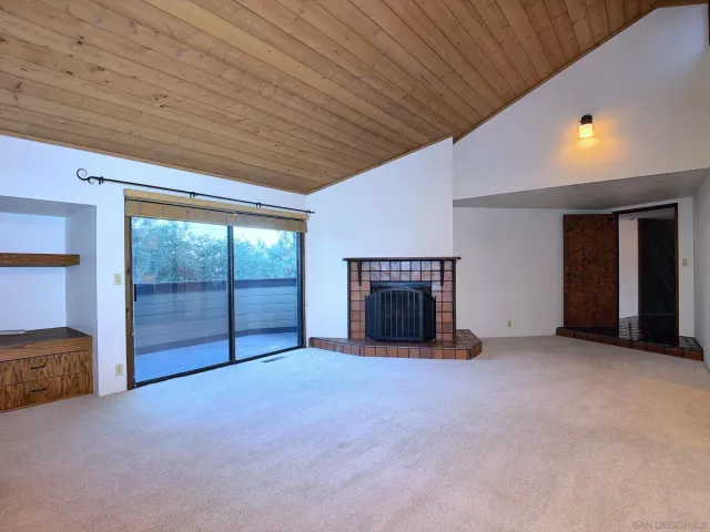 a view of an empty room with a fireplace