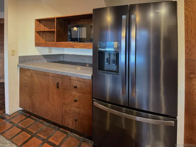 a bathroom with a refrigerator and a sink