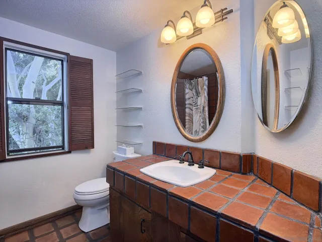 a bathroom with a toilet sink and mirror