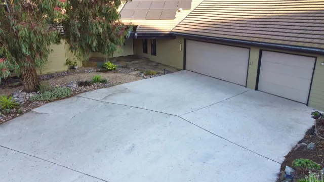 a front view of a house with plants