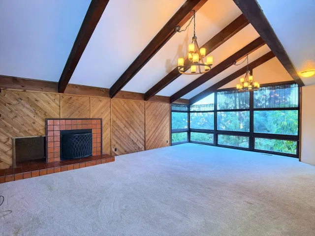 a view of an empty room with a fireplace