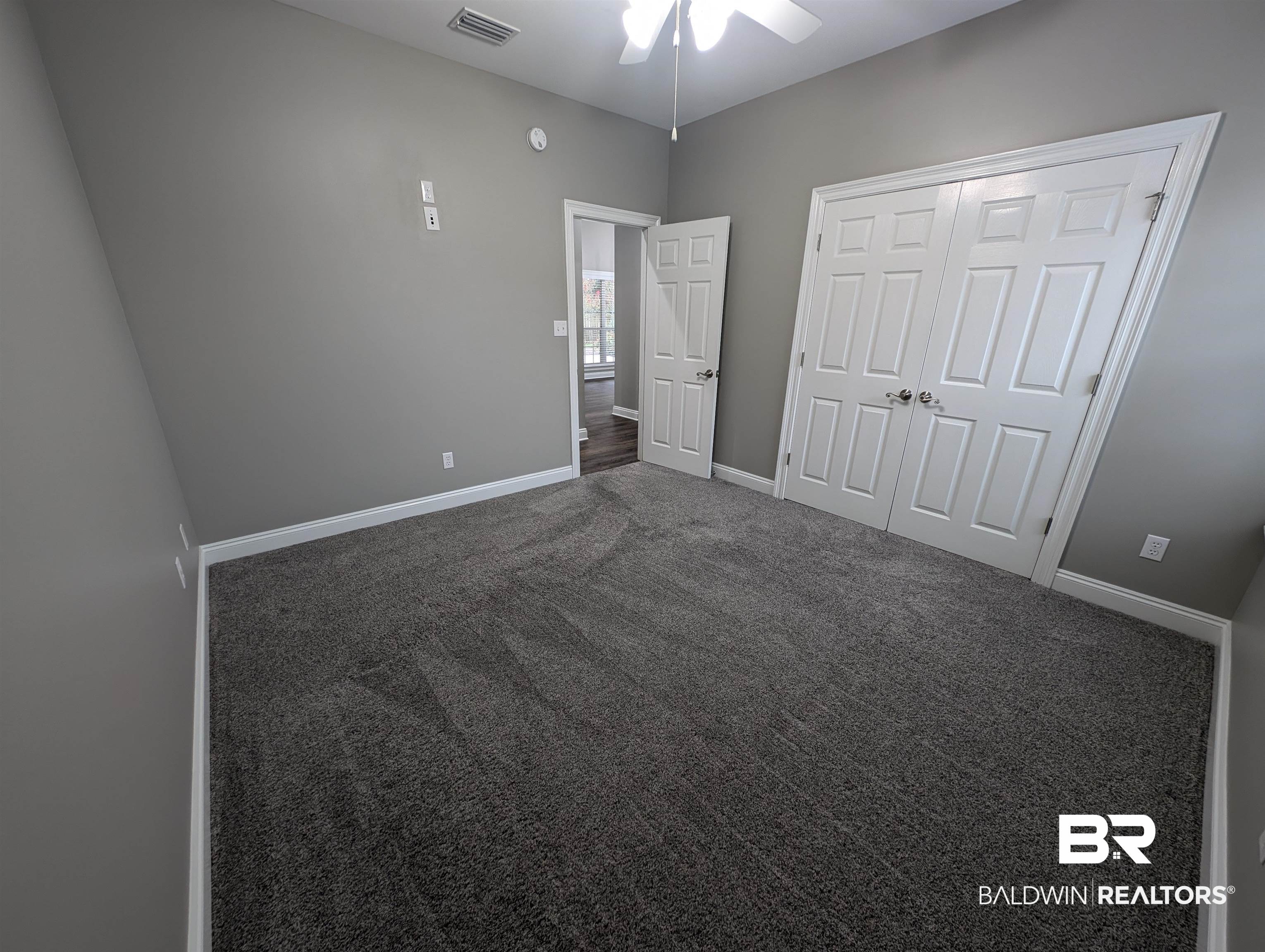 11623 Halcyon Loop Daphne, AL 36526 - Photo 46 of 90 The second guest bedroom with a closet, dark colored carpet, and ceiling fan
