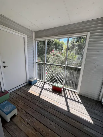 a sitting area with wooden floor