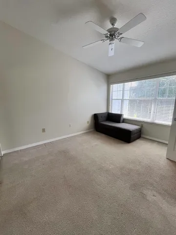 a view of room with a ceiling fan and a ceiling fan