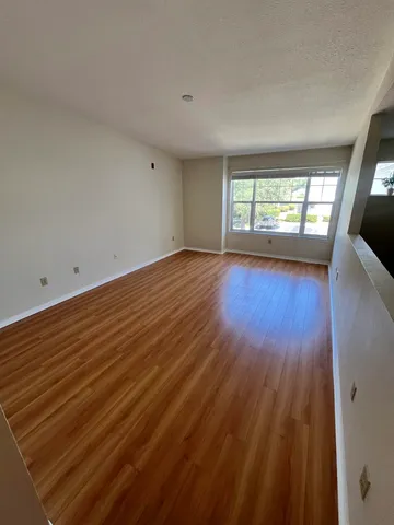 a kitchen with stainless steel appliances granite countertop a refrigerator a stove and a sink