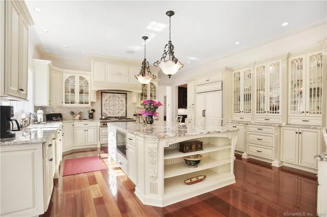 a large white kitchen with stainless steel appliances