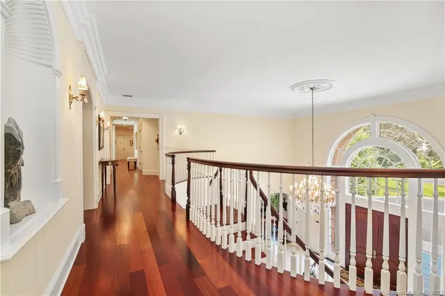 a view of staircase with wooden floor and a window