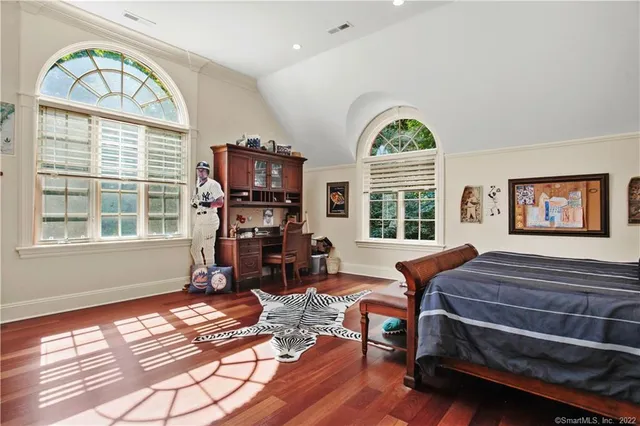 a living room with furniture a fireplace and a large window