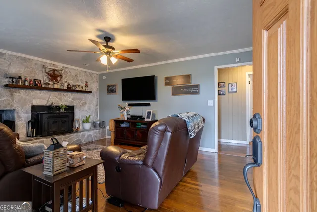 a living room with furniture a fireplace and a flat screen tv