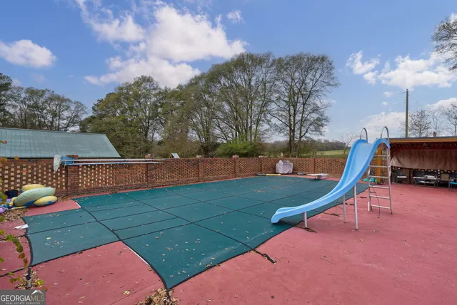 an aerial view of a house with a yard basket ball court and outdoor seating