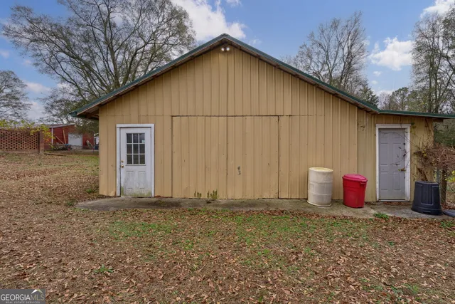 an aerial view of a house with a yard basket ball court and outdoor seating
