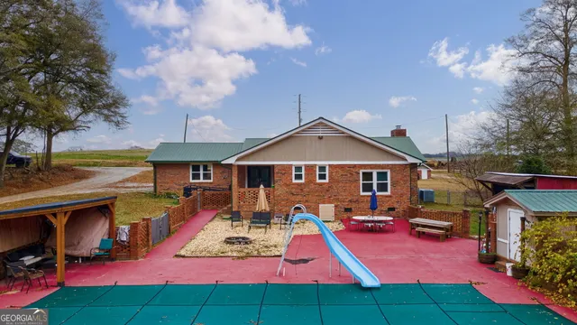 a front view of house with yard patio and fire pit