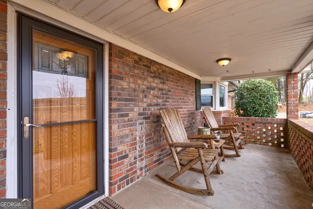 a view of an outdoor sitting area with brick walls