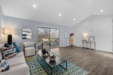 a living room with furniture a lamp and a table