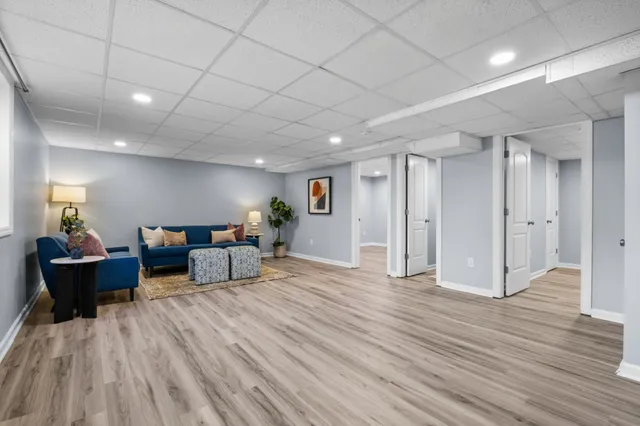 a living room with furniture and wooden floor