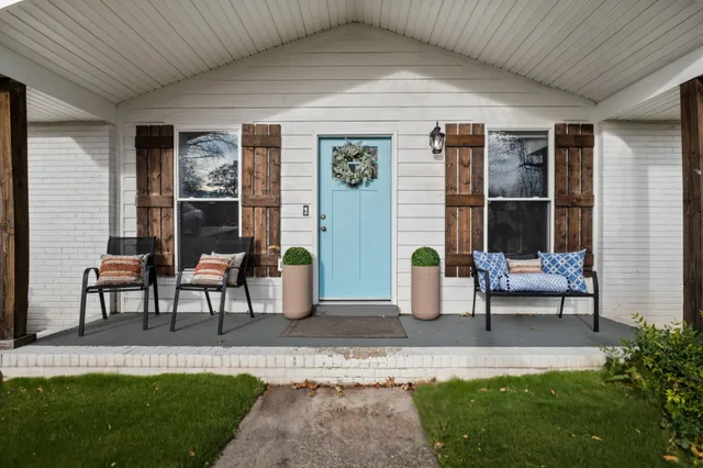 a house view with a seating space and garden