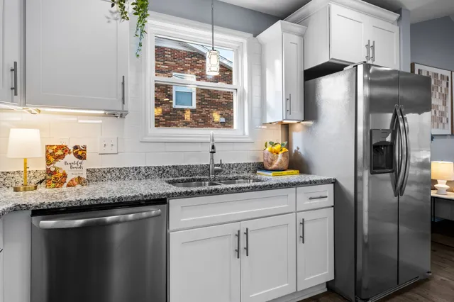 a kitchen with stainless steel appliances granite countertop a refrigerator and a sink